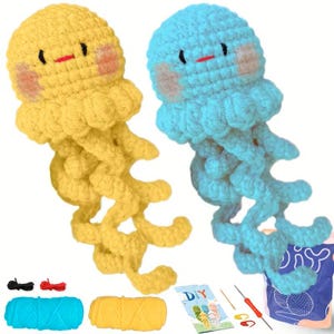 May include: Two crocheted jellyfish toys, one yellow and one blue, with smiling faces and dangling tentacles. The image includes yarn, crochet hooks, and a DIY instruction booklet, suggesting a craft kit.