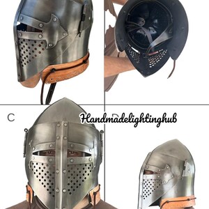 Pode incluir: Um capacete medieval com viseira e m&aacute;scara de malha. O capacete &eacute; feito de metal e tem uma correia de couro marrom. O capacete &eacute; mostrado de diferentes &acirc;ngulos.