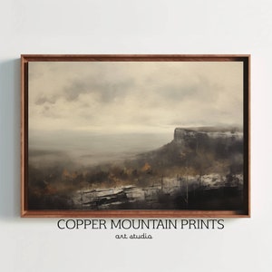 May include: A framed painting of a misty landscape with a cliff in the distance. The painting is in shades of gray and brown, with a hint of green in the foreground. The painting is titled "Copper Mountain Prints art studio".
