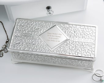 May include: A rectangular silver jewelry box with floral detailing and a diamond-shaped plaque. The plaque is engraved with the text "Happy Mother's Day To the best Mummy In the world!!! Love Arthur & Ida."