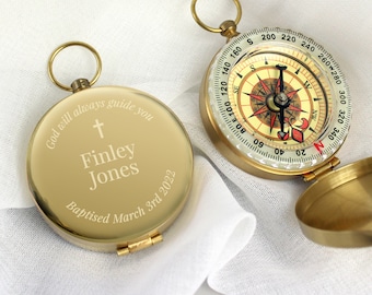 May include: Gold compass with a cross and the inscription "God will always guide you Finley Jones Baptised March 3rd 2022".