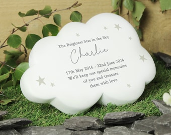 May include: White cloud-shaped memorial stone with the text "The Brightest Star in the Sky" and "Charlie" in cursive. The dates "17th May 2016 - 22nd June 2024" are also included, along with the message "We'll keep our special memories of you and treasure them with love."