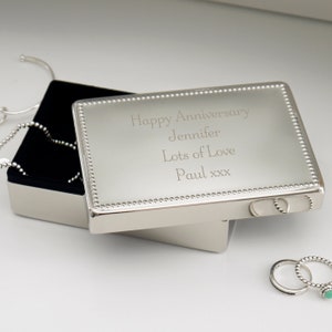 May include: Silver jewellery box with a beaded border and an engraved message: "Happy Anniversary Jennifer Lots of Love Paul xxx".