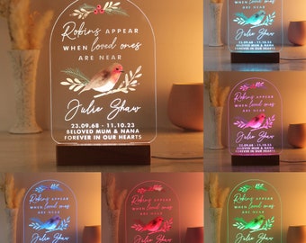 May include: A color-changing LED night light with a robin design and the text "Robins appear when loved ones are near." The light also includes the name "Julie Shaw" and the dates "23.09.68 - 11.10.23" with the text "Beloved Mum & Nana Forever in our hearts."