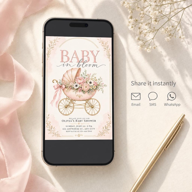 May include: A smartphone displaying a digital baby shower invitation with the text BABY in bloom, featuring a pink vintage baby carriage filled with flowers, gold wheels, and event details for Olivia's baby shower on Sunday, June 14 at 2 PM.