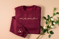 Embroidered custom Mama Sweatshirt: Kid Names on Sleeve -Perfect for Mothers Day, Birthday, New Mom - best gift for mom product logo