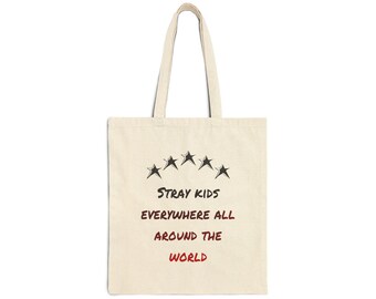 May include: A beige tote bag with black text that reads "Stray Kids Everywhere All Around The World" and five black stars above the text.