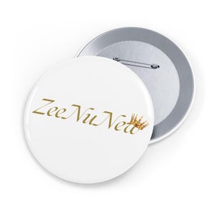 May include: White button with gold text "Zee Nu Net" and a gold crown graphic. A silver button back is partially visible. The button is a round, promotional item.
