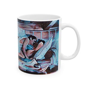 May include: White ceramic mug featuring a romantic illustration of two people in bed, embracing. The artwork is rendered in soft colors, with a focus on the figures and the intimate setting. The mug has a standard handle.