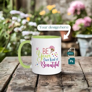 May include: White ceramic mug with a green rim. The mug has a colorful design that says "Be Your Own Kind of Beautiful" with a pink flower and butterflies.