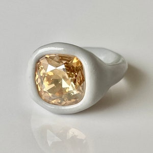 Bold chunky cocktail handcrafted ring with glossy porcelain look and champagne color swarovski cushion shape crystal