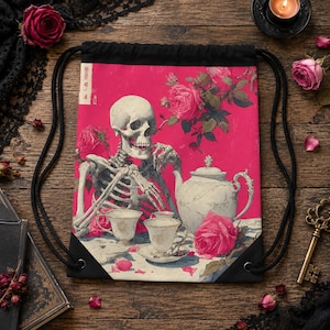 May include: A black drawstring backpack featuring a vibrant magenta background with a graphic illustration of a human skeleton sitting at a table with a white teapot and teacups, surrounded by pink roses and a vertical strip of Japanese text.