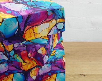 May include: Two colourful boxes stacked on top of each other. The boxes are covered in a vibrant abstract pattern of blue, yellow, purple, and red swirls and circles.