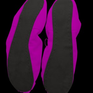 May include: A pair of pink ballet slippers with black soles. The slippers are made of a soft, flexible material and are designed for comfort and support.