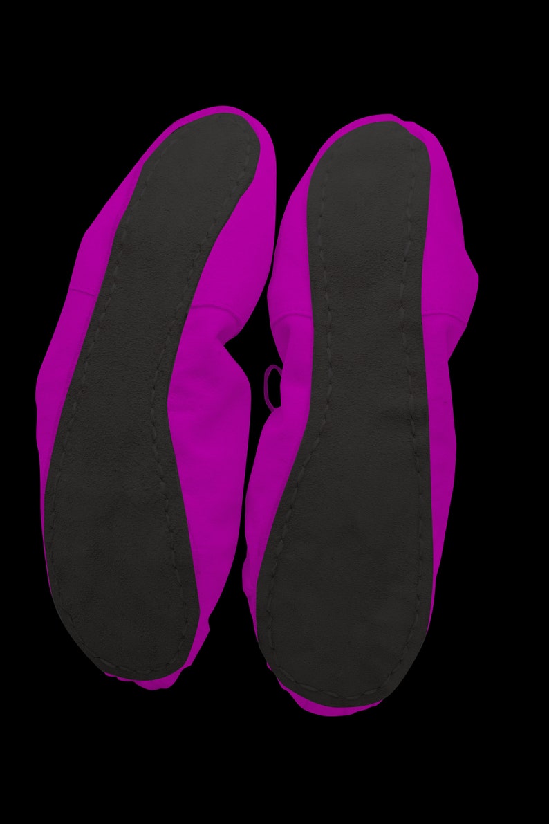 May include: A pair of pink ballet slippers with black soles. The slippers are made of a soft, flexible material and are designed for comfort and support.