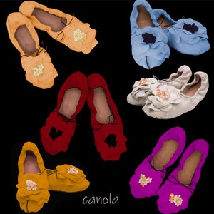 May include: Ten pairs of colorful fabric slippers with floral embellishments. The slippers are in various colors, including red, blue, white, yellow, and pink.