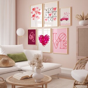 May include: A pink wall gallery with six framed prints featuring hearts, a lock and key, a tic-tac-toe game, a red truck with hearts, and the word "LOVE" in pink and red.