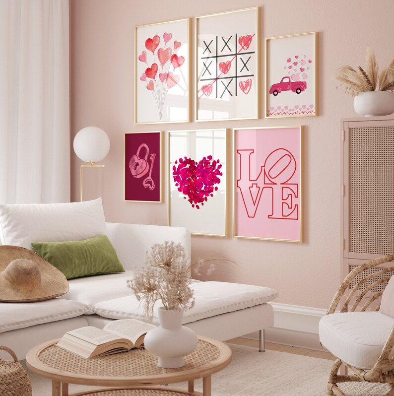 May include: A pink wall gallery with six framed prints featuring hearts, a lock and key, a tic-tac-toe game, a red truck with hearts, and the word "LOVE" in pink and red.