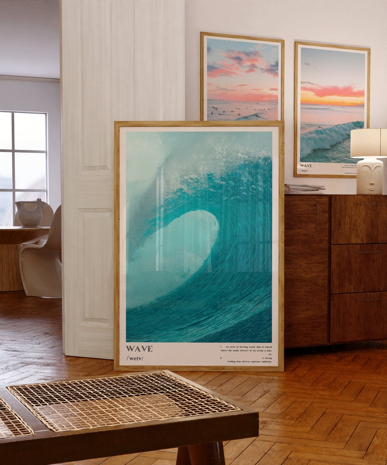 May include: A framed poster with a blue and green watercolor painting of a large wave crashing. The poster has the word "WAVE" and the phonetic spelling "/weɪv/" printed below the image.