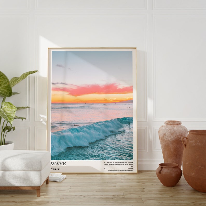 May include: A poster with a photograph of a large wave crashing in the ocean at sunset. The sky is a vibrant pink and orange. The poster has the word "WAVE" and the phonetic spelling "/weɪv/" printed at the bottom. The definition of the word "wave" is printed below the phonetic spelling.