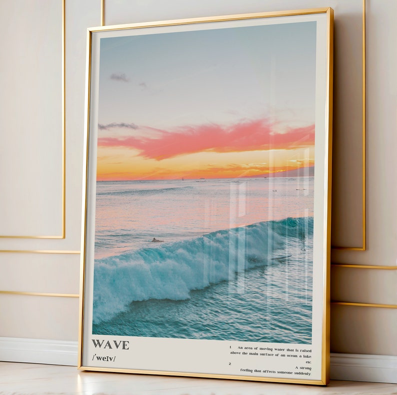 May include: A digital art print with a sunset over the ocean and a large wave crashing. The print has the word "WAVE" and the phonetic spelling "/'welv/" at the bottom. The text below the word "WAVE" defines the word "wave" as a "rise of moving water that is rolled above the main surface of an ocean, a lake, etc." and a "strong feeling that affects someone suddenly."