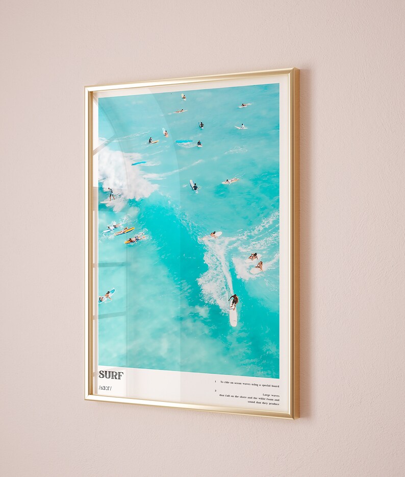 May include: A framed poster with a photograph of surfers riding waves in turquoise water. The poster has the word "SURF" in bold, black letters and a list of instructions for surfing.