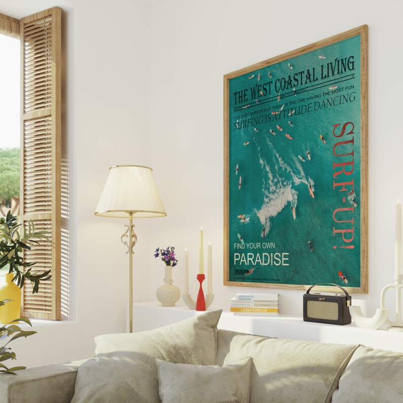 May include: A teal and white poster with the text "The West Coastal Living" and "Surf Up!"  The poster features a photo of surfers in the ocean with a wave breaking in the background. The text "The best surfer out there is the one having the most fun. Surfing is attitude dancing." is printed on the poster. The text "Find your own paradise" is printed at the bottom of the poster.