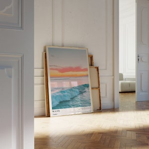 May include: A framed poster with a photograph of a large wave crashing in the ocean at sunset. The poster has a gold frame and the text "WAVE (weɪv)" at the bottom.