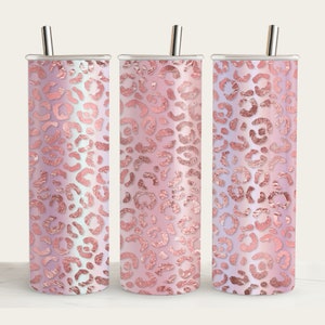 May include: Three stainless steel tumblers with lids and straws. The tumblers are covered in a pink and white leopard print with a rose gold foil effect.
