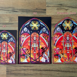 May include: Three different sizes of a print featuring a stained glass window design with a red, yellow, and blue color scheme. The window depicts a winged figure with a halo and other figures in the background. The text "A5", "A4", and "Premium Gold" are printed below each print.