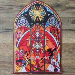 May include: A stained glass window design featuring a red and white angel with wings spread wide. The angel is surrounded by other characters, including a red devil, a pink and white demon, and a white angel. The window is framed in gold.