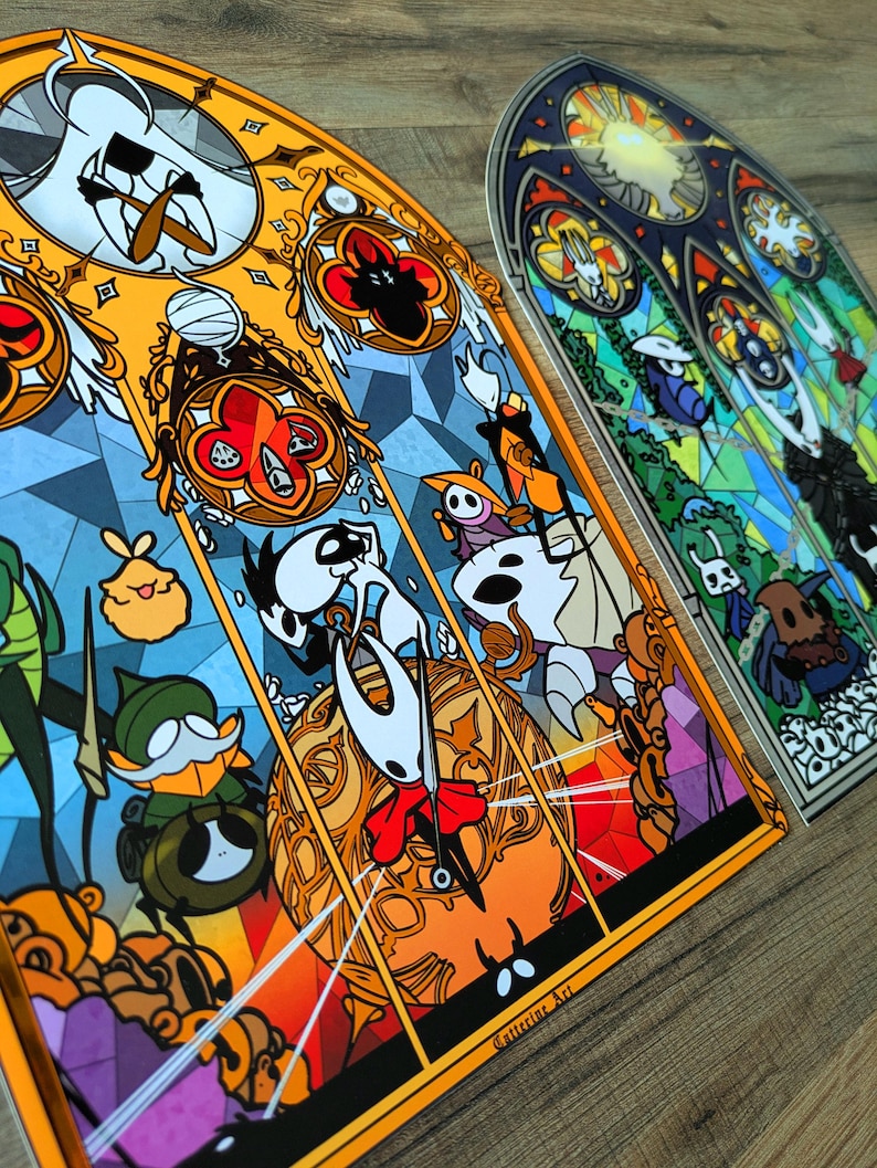 May include: Two stained glass art pieces with vibrant illustrations of video game characters. The artwork is designed to resemble stained glass windows, with orange, yellow, blue, and green colours. The text "Cutterine Art" is visible.