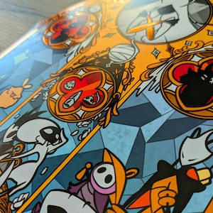 May include: A detailed illustration with a stained-glass aesthetic. The artwork features a vibrant colour palette of orange, blue, and red, with stylized figures and geometric shapes. The design has a fantasy theme, with intricate details and a decorative border.