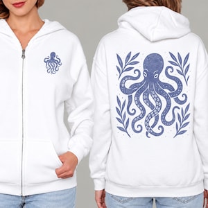May include: A white zip-up hoodie featuring a small blue octopus graphic on the left chest and a large, detailed blue octopus illustration surrounded by stylized leaves on the back. The garment includes a hood, long sleeves, and a front zipper.