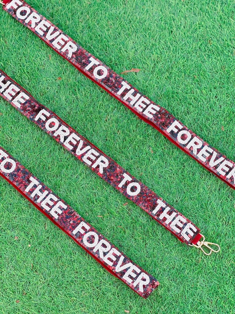 May include: Three red velvet ribbon keychains with white sequins and the text "Forever to thee Forever" repeated on each.