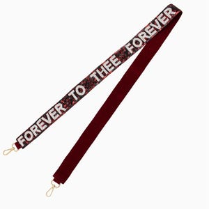 May include: A red velvet and sequined bag strap with gold clasps. The strap features the text "FOREVER TO THEE FOREVER" in white.