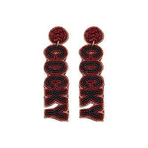 May include: A pair of red and black beaded earrings spelling out the word "Rocky" in black beads.