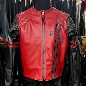 May include: A red and black leather jacket featuring a full-length front zipper, quilted shoulder panels, and black vertical stripes on the front. The word STEVE is embroidered in black lettering on the left chest area of the jacket.
