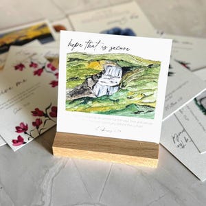 Memory Verse Scripture Card of "hope that is secure" and watercolor painting artwork, along with an oak wood display stand.