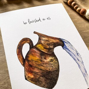 May include: A watercolor painting of a brown clay pitcher pouring out a stream of blue water. The text "he lavished on us" is written in black cursive above the pitcher.