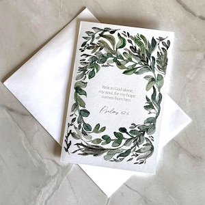 May include: A white greeting card with a watercolor floral design in shades of green and gray, and the text "Rest in God alone, my soul, for my hope comes from him. Psalms 62:5." The card is paired with a white envelope.