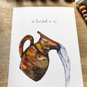 May include: A watercolor painting of a brown clay pitcher pouring water. The text "he lavished on us" is written above the pitcher.