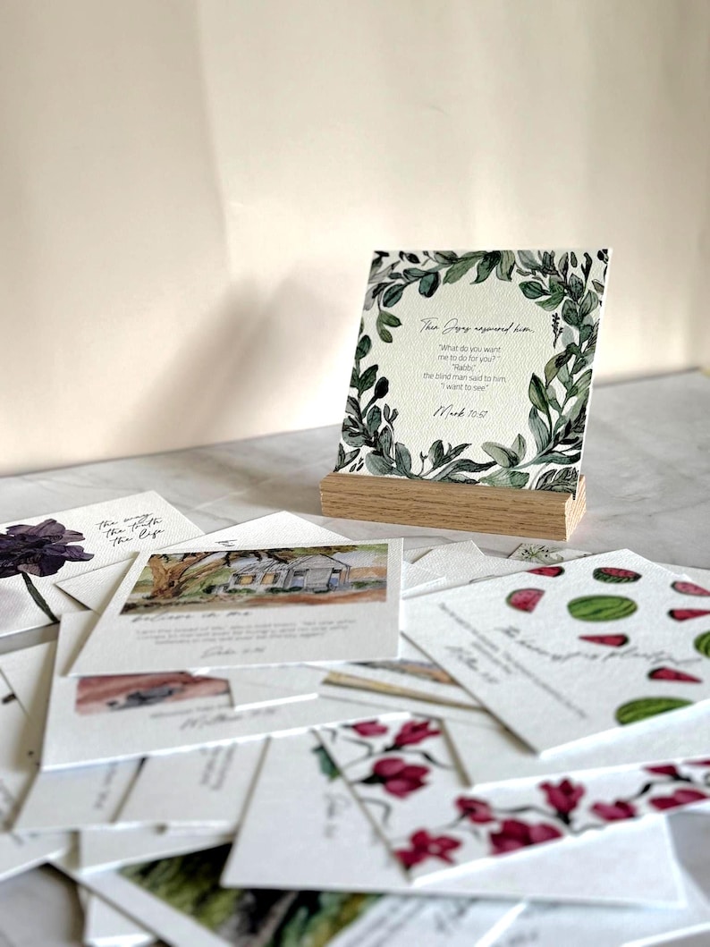 Memory Verse Scripture Card of Mark 10:57 and watercolor painting artwork, along with an oak wood display stand.