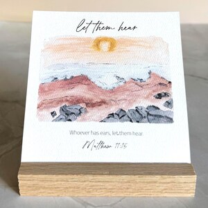 Memory Verse Scripture Card of "Let them hear" and watercolor painting artwork, along with an oak wood display stand.