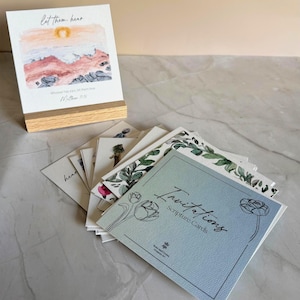 Memory Verse Scripture Card of "Let them hear" and watercolor painting artwork, along with an oak wood display stand. Other scripture cards displayed