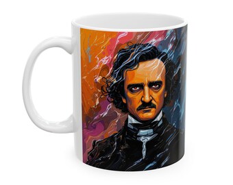 May include: White ceramic coffee mug featuring a colorful portrait of Edgar Allan Poe. The artwork depicts Poe with dark hair and a mustache, set against a vibrant background of orange, purple, and blue hues. The mug has a white handle.