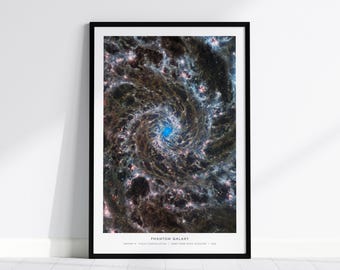 May include: A framed vertical wall art print featuring the Phantom Galaxy, showcasing a swirling spiral structure with dark dust lanes and bright star clusters. The center glows with a vibrant blue light. Text at the bottom reads PHANTOM GALAXY, MESSIER 74, PISCES CONSTELLATION, JAMES WEBB SPACE TELESCOPE, 2022.