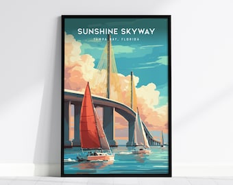 May include: A framed art print featuring the Sunshine Skyway Bridge in Tampa Bay, Florida. The artwork depicts sailboats on the water with the bridge in the background. The sky is a mix of blue and orange hues, and the print is in a black frame.