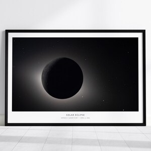 May include: A framed horizontal wall art print featuring a black and white depiction of a solar eclipse against a starry sky. The text "SOLAR ECLIPSE" is printed in white at the bottom center, followed by "ASTRONOMY | LUNAR EVENT | APRIL 8, 2024".