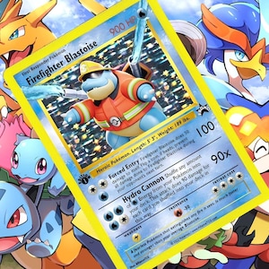 May include: A Pokemon trading card featuring a blue Blastoise wearing a firefighter's helmet and uniform. The card text reads "First Responder Pokemon Firefighter Blastoise 900 HP".